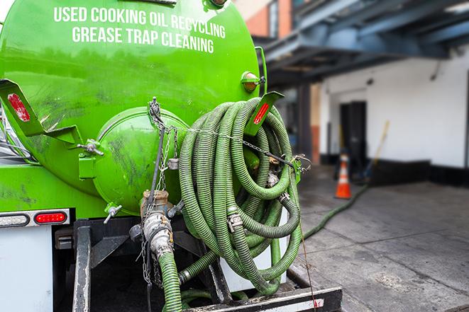 a technician pumping a grease trap in a commercial building in Fruitland Park